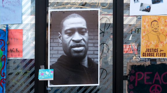 Posters of George Floyd stuck on a glass door